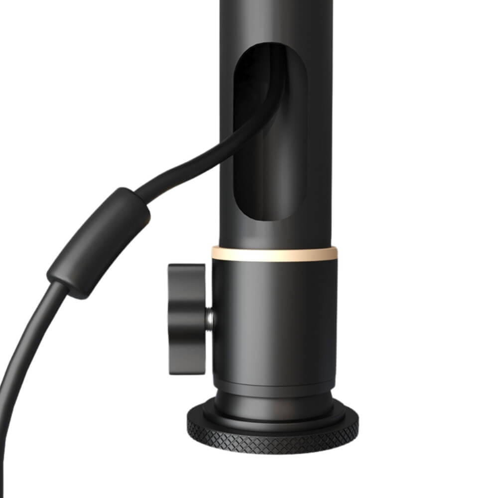 Photograph of a matte black professional desk mount base with an integrated cable management slot, a subtle gold accent ring, and a knurled adjustment knob and base on a white studio background